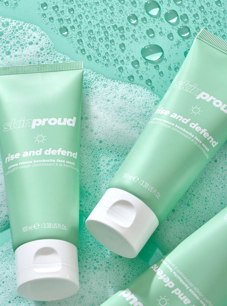 Three bottles of Skin Proud Rise and Defend Face Wash in bubbles